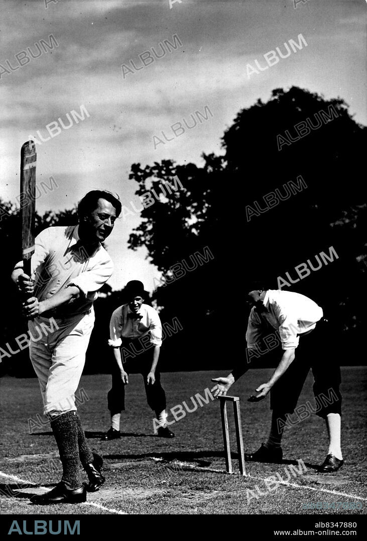 Batting Back 200 Years -- Mr. John Moore, the well-known author batting for the Gentlemen in the 200- year-old cricket match.
A team of Professor A.H. Smith's Gentlemen met the Dumbleton C.C. In a cricket match at the village of Dumbleton, near Tewkesbury, played according to the rules of 1751. Two stumps only were used, bowling was underhand, the players wore knee breeches, and the umpire was supplied with a bat. August 22, 1951. (Photo by Fox Photos).