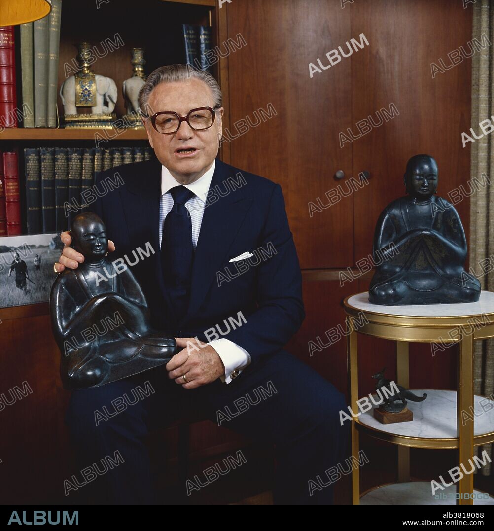 Nelson Rockefeller holding a reproduction of a 16th century bronze Shinto priest. The original is part of his private collection. Photographed in 1978.