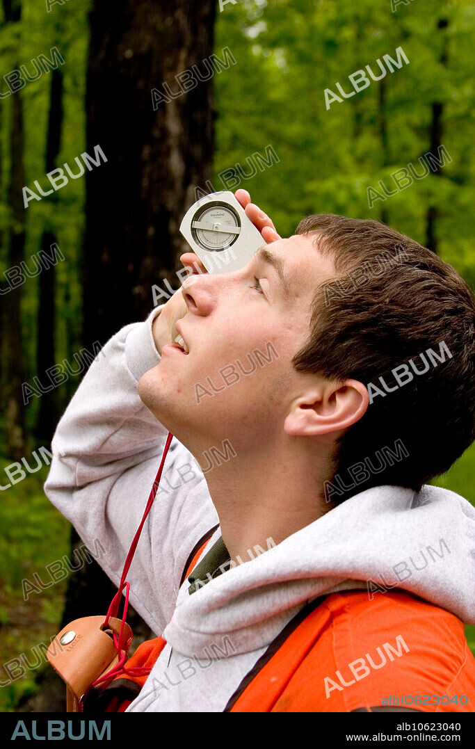 A Clinometer is used to determine tree height. It is one of the tools being used to determine the quantity and marketability of the lumber in this private woodland in Taylor County Wisconsin.