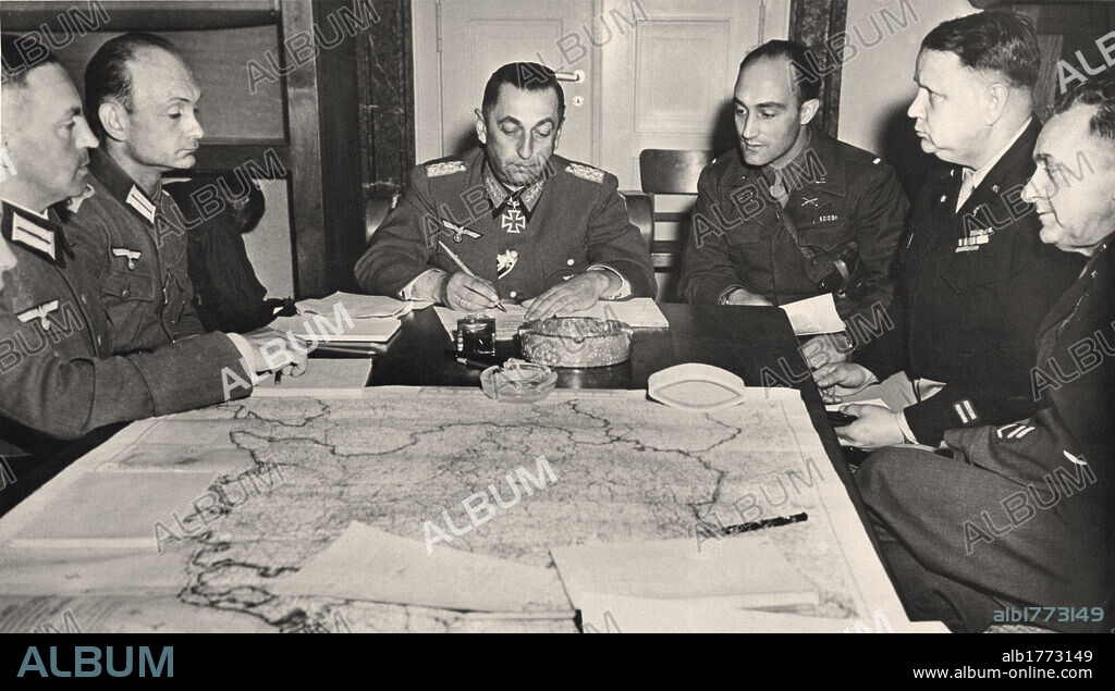 Surrender of the German troops to the Allies in Bavaria. In a house in Haar, General Hermann Foertsch, Commander of 1st Army, signs the unconditional surrender of his unit and of 19th and 24th Army units, in front of General Jacob Devers (not present in the photo) and his assistants. Haar, May 5, 1945.