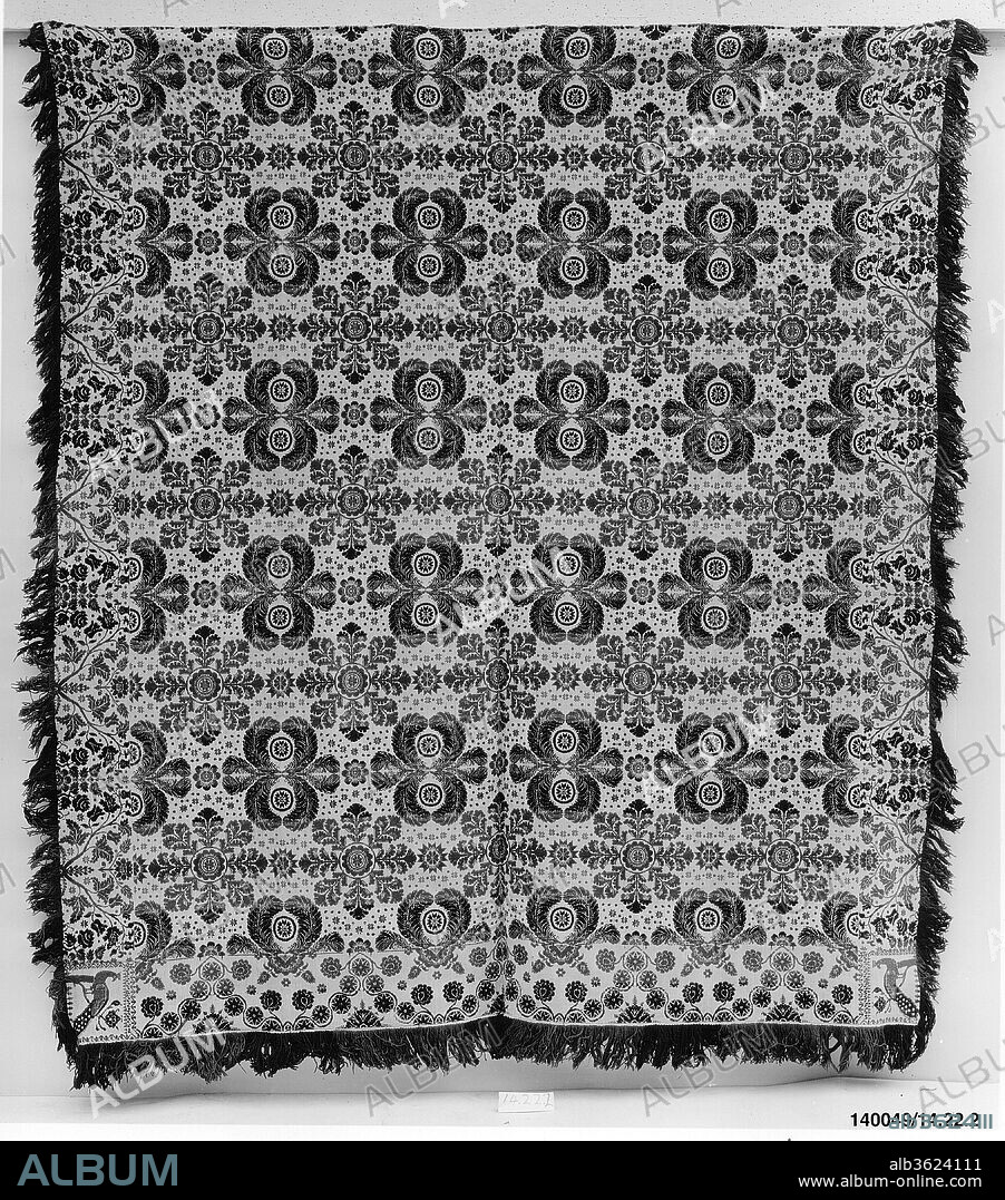 Coverlet. Culture: American. Dimensions: 98 1/2 x 89 3/4 in. (250.2 x 228 cm). Date: ca. 1840.
This coverlet is woven in two panels and seamed at the center. It has a warp of undyed and light blue cotton and a weft of dark blue, green, and red wool and undyed cotton. The central field shows feather medallions alternating with foliate medallions. The bottom border has a stylized vine motif, and the right and left borders have roses and tulips. Peacocks adorn each of the two corner blocks. Both sides of the coverlet have natural fringe, and there is attached fringe along the bottom edge.