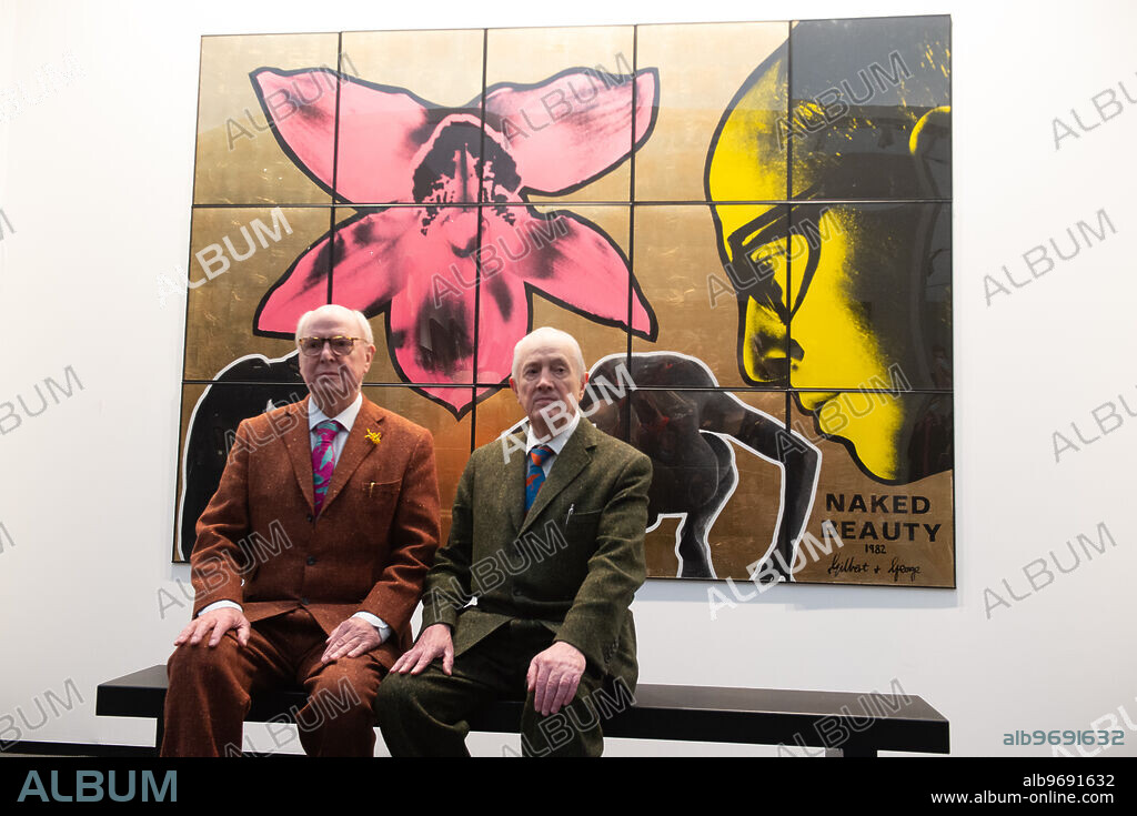 Artists Gilbert Prousch (in green) and George Passmore (in maroon) aka Gilbert & George pose in front of their artwork 'Naked Beauty' (1982) at a preview of Thaddeus Ropac's stand at Frieze Masters in Regent's Park, London, England, UK on Wednesday 13 October, 2021., Image: 637844244, License: Rights-managed, Restrictions: Please credit photographer and agency when publishing as Justin Ng/UPPA/Avalon., Model Release: no, Credit line: Justin Ng / Avalon.