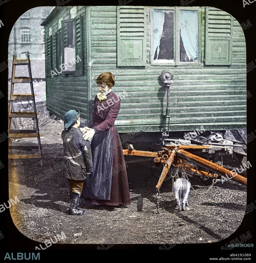 Magic lantern slide circa 1900.Victorian/Edwardian.Social History. Mrs Isabel Reaney story of Willie Wills Wings and slide show a christian story . Life model painted background. Slide 10 'Mother, I've got a customer for a comb'. A boy wroking for parents selling combs.