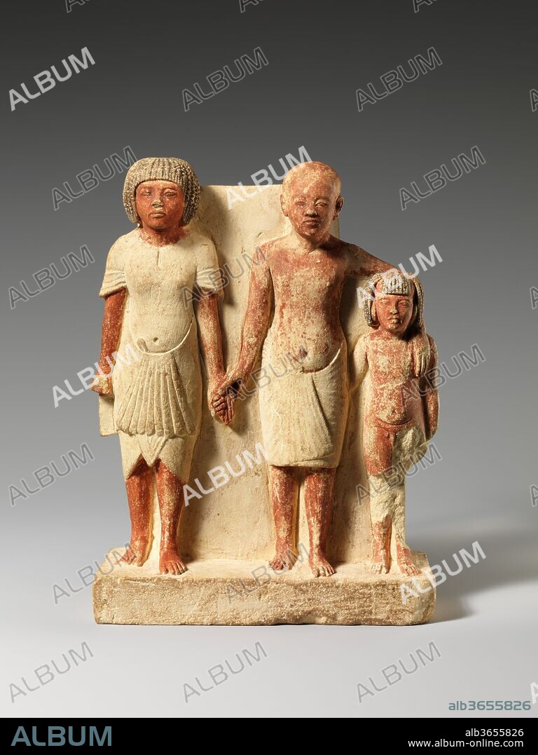 Statue of two men and a boy that served as a domestic icon. Dimensions: h. 17 cm (6 11/16 in); w. 12.5 cm (4 15/16 in); 
D of base next to man 5.7 cm (2 1/4 in); D next to boy 4.8 cm (1 7/8 in). Dynasty: Dynasty 18. Reign: reign of Akhenaten. Date: ca. 1353-1336 B.C..
All of the individuals in this small group are males, represented according to the conventions of Amarna art. The intriguing group has been variously interpreted as a family comprising a grandfather, a father, and a son, or as one man at three different stages of life. The latter is most unlikely as the multiple representations of a single individual in one statue are not shown interacting as they do here. In fact careful examination of the faces and figures points to the statue's being a kind of domestic icon. The figure at left is a high-status individual and likely the oldest; he is probably a revered relative or the respected overlord of the man and boy who stand closely entwined with one another. The statuette would probably have received veneration in the household of its owner.