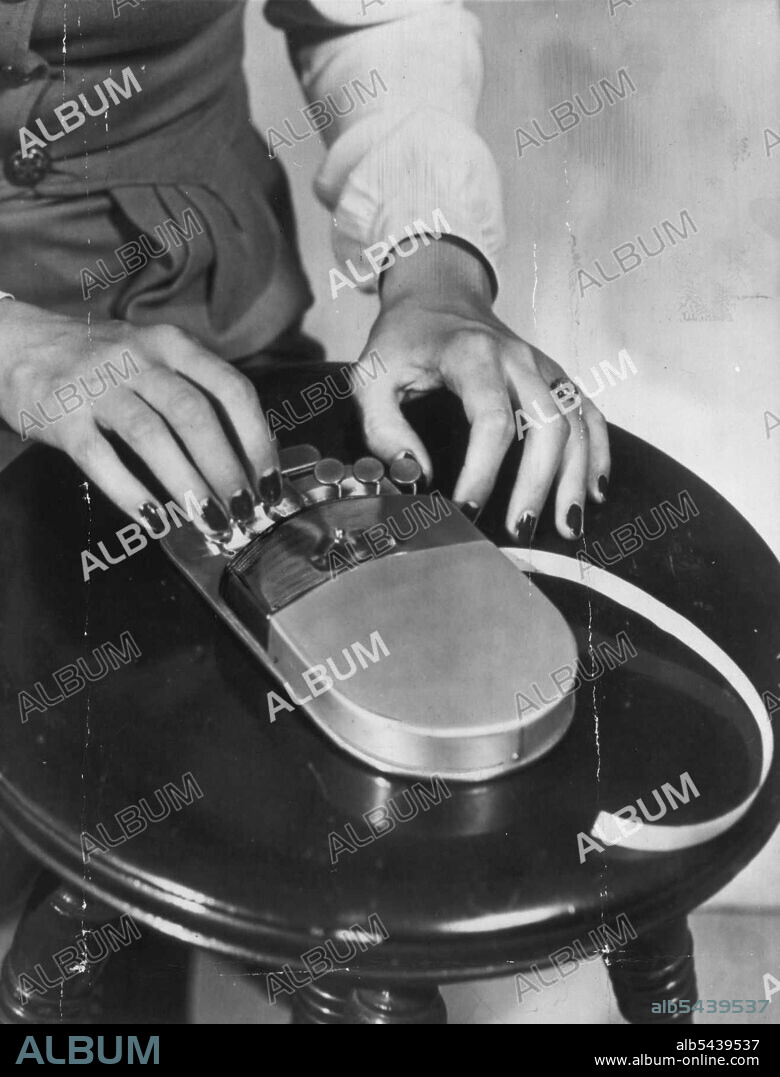 Braille 'Typewriter' Demonstrated -- This is the six-key vestpocket "typewriter" called the equivalent or a Braille pen and pencil for the blind which was demonstrated here yesterday by its inventor, Dr. Alfred banks, former San Diego city health officer. The device, which stamps Braille characteristics in thin paper tape, will be distributed by the San Diego lions club on a non-profit basis. April 17, 1946. (Photo by AP Wirephoto). ;Braille 'Typewriter' Demonstrated -- This is the six-key vestp.