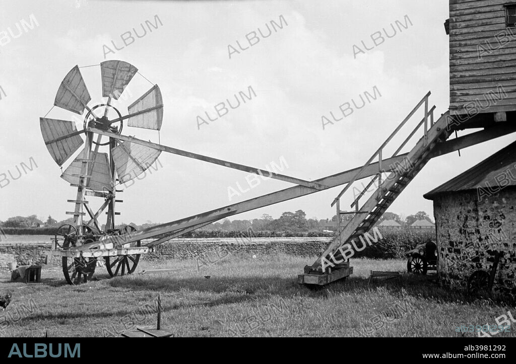 Fan staging at Tottenhill post mill, Norfolk, 1936. The fantail is a device for rotating the mill in order to keep the sails facing the wind at all times. This example is known as a ladder fantail and is most commonly associated with Suffolk, but is also found elsewhere.