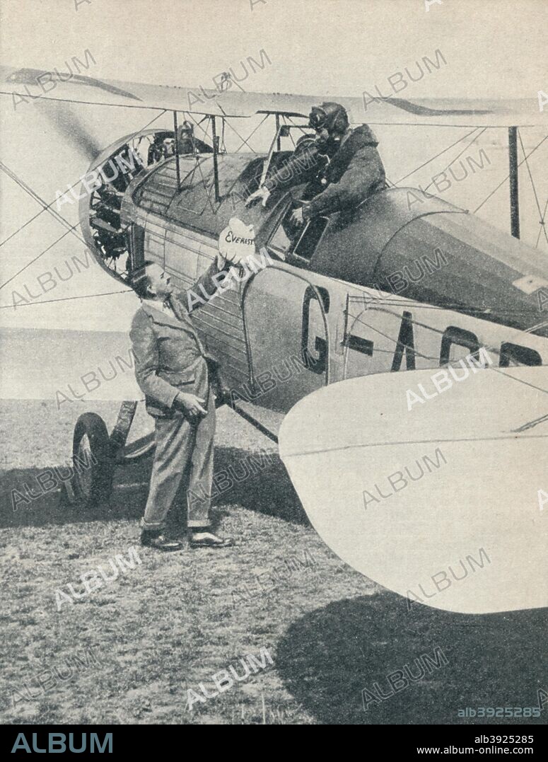 Before the first flight over Mount Everest, 1933 (c1937). The Everest mail being handed to the pilot of the Westland Wallace aircraft by Colonel PT Etherton. The mail contained letters to King George V, the Prince of Wales and the Late Lady Houston. On 3 April 1933 Scottish airmen Douglas Douglas-Hamilton, Marquis of Clydesdale, and Flight Lieutenant David McIntyre became the first aviators to fly over Mount Everest. The flight was part of the Houston Mount Everest Expedition. From Wonders of World Aviation, Vol. 1, by Clarence Winchester. [The Amalgamated Press Ltd, London, c1937].