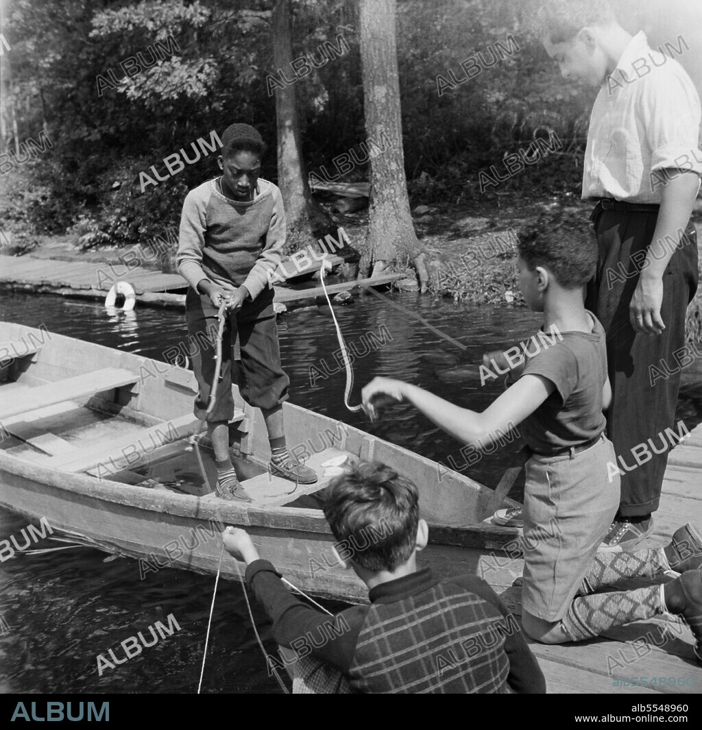 GORDON PARKS. Southfields, New York. Interracial activities at Camp Nathan Hale, where children are aided by the Methodist Camp Service. Fishing is one of the popular activities.