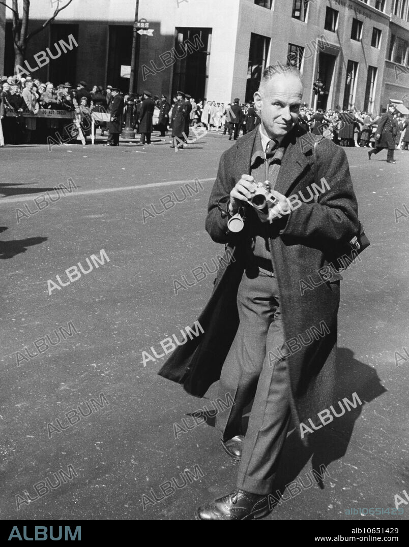 Editorial use only . Henri Cartier-Bresson, photographed on 5th Ave, in New York City, during St. Patrick's Day; undated.