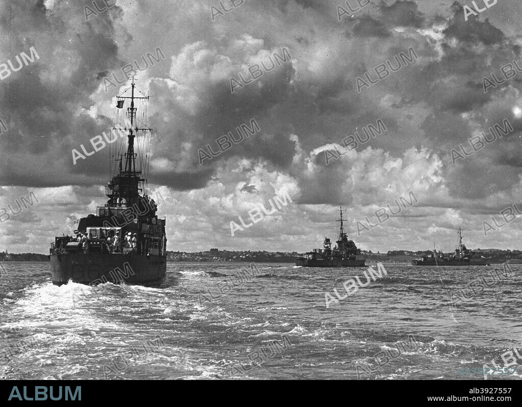 British warships entering Sydney harbour, Australia, 1945. Three destroyers escorting the battleship 'King George V'.