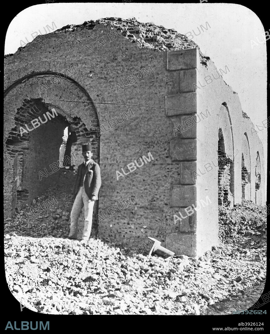 The ruins of the Mahdi's tomb in Omdurman, Sudan, c1898. Muhammad Ahmad bin Abd Allah (1844-1885) was a Sudanese Muslim leader who, in 1881, proclaimed himself the Mahdi, the messianic redeemer of the Islamic faith. He led a rebellion against the Turkish/Egyptian government of the Sudan, which culminated in the capture of the capital city, Khartoum, in 1885. Muhammad Ahmad died shortly afterwards, and was buried in nearby Omdurman. After the fall of Khartoum, in which the British Governor-General of the Sudan, General Charles Gordon, was killed by Mahdist warriors, the British joined the Egyptians in preaparign to fight a war to drive out the Mahdists. They were eventually successful, winning a decisive battle at Omdurman in April 1898. The Mahdi's tomb was destroyed by the victors in order to prevent it from becoming a future rallying point for Mahdists, but was later rebuilt. Lantern slide.