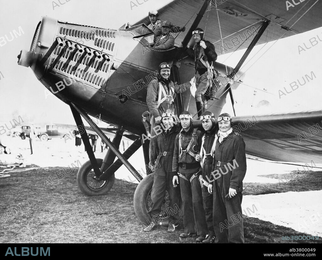 Members of the refueling planes involved in the record-breaking Question Mark flight (January 1st - 7th, 1929).  Left to right:  Captain Ross G. Hoyt (pilot); Lt. Odas Moon (pilot); Lt. A.C. Strickland; Lt. Joseph G. Hopkins; Lt. Andrew F. Sotter; Lt. I.A. Woodring.  The two men in the cockpit are mechanics.