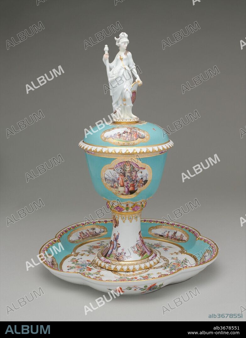 Standing cup with cover and stand. Culture: German, Meissen. Dimensions: Overall, cup: 15 1/2 x 6 1/4 in. (39.4 x 15.9 cm); Overall, stand: 1 1/2 x 11 1/2 in. (3.8 x 29.2 cm). Factory: Meissen Manufactory (German, 1710-present). Modeler: Johann Joachim Kändler (German, Fischbach 1706-1775 Meissen). Date: ca. 1735.
Commissioned by Augustus the Strong, Elector of Saxony and King of Poland, to commemorate the state visit to Dresden in January 1728 of the king and queen of Prussia, parents of Frederick the Great. The queen's initials, SD for Sophie-Dorothea, are three times displayed. The larger finial figure of Athena is closely related to a silver statuette in the Electoral collections at Dresden, made by Philipp Kuesel of Augsburg before 1700. The turquoise ground has reserves with gold-lace borders painted by Heroldt with colorful chinoiserie figures in idyllic landscapes. This splendid cup illustrates that interesting phase of early Meissen production when the compelling influence of all things Chinese had been superseded by a temporary dependence on silver shapes; the lure of the Orient continued in the painted decoration.