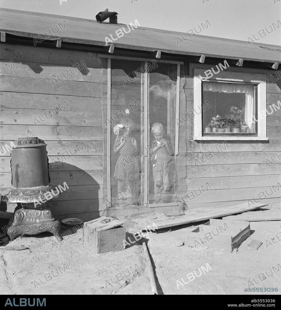 DOROTHEA LANGE. Two of the seven Browning children in doorway of their Oregon home. Dead Ox Flat. Malheur County, Oregon.