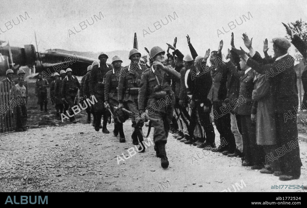 Italian Grenadiers in Tirana. A unit of Italian grenadiers, just off the plane at the airport of the Albanian capital Tirana, heading towards the city receiving greetings from several civilians. Tirana, 7th April 1939.