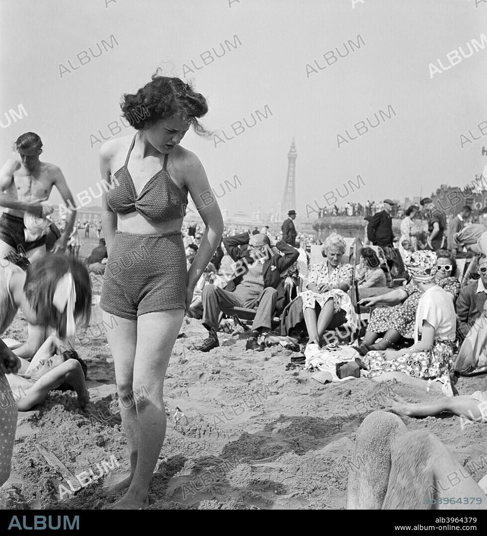 A young woman in a knitted bathing costume on the beach, Blackpool,  c1946-1955. Artist: John Gay - Album alb3964379