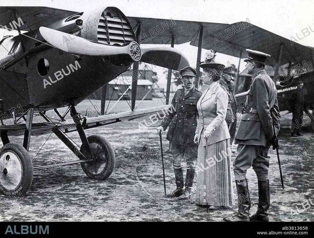 Caption: "Air Marshal Trenchard shows a De Havilland bomber to Queen Mary." Mary of Teck (May 26, 1867 - March 24, 1953) was Queen of the UK and the British Dominions, and Empress of India, as the wife of King George V. During WWI, Queen Mary instituted an austerity drive at the palace, where she rationed food, and visited wounded and dying servicemen in hospital, which she found a great emotional strain. As queen consort from 1910, she supported her husband through the First World War, his ill-health and major political changes arising from the aftermath of the war and the rise of socialism and nationalism. Hugh Montague Trenchard (February 3,1873 - February 10, 1956) was a British officer who was instrumental in establishing the Royal Air Force. He held several senior positions in the Royal Flying Corps during WWI, serving as the commander of the Royal Flying Corps in France from 1915-17. In 1918, he briefly served as the first Chief of the Air Staff before taking up command of the Independent Air Force in France. Returning as Chief of the Air Staff under Churchill in 1919, Trenchard spent the following decade securing the future of the Royal Air Force.