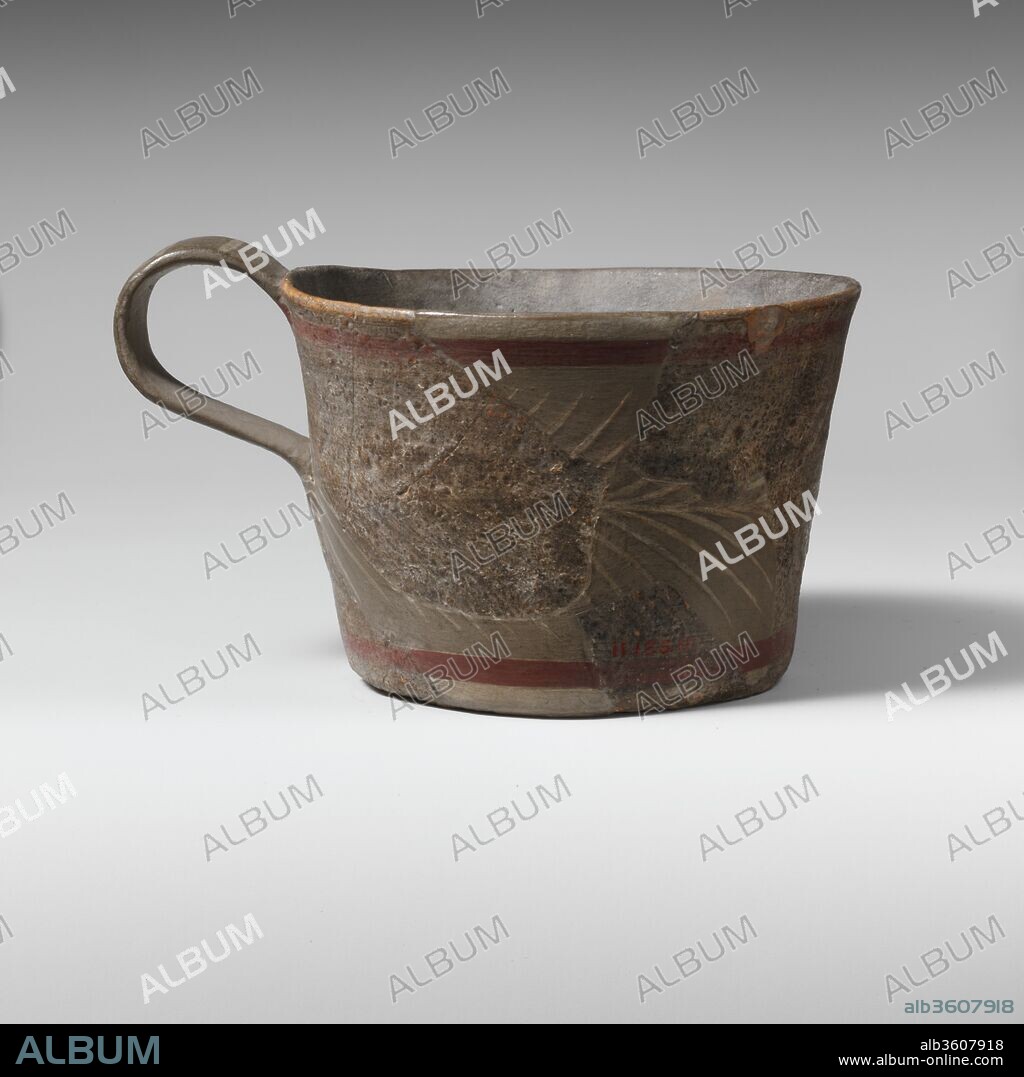 Terracotta straight-sided cup. Culture: Minoan. Dimensions: H. as restored 2 7/8 in. (7.3 cm.)
Diameter as restored 4 11/16 in. (11.9 cm.). Date: ca. 1750-1700 B.C..
On the body a fern pattern in white between red and white bands.