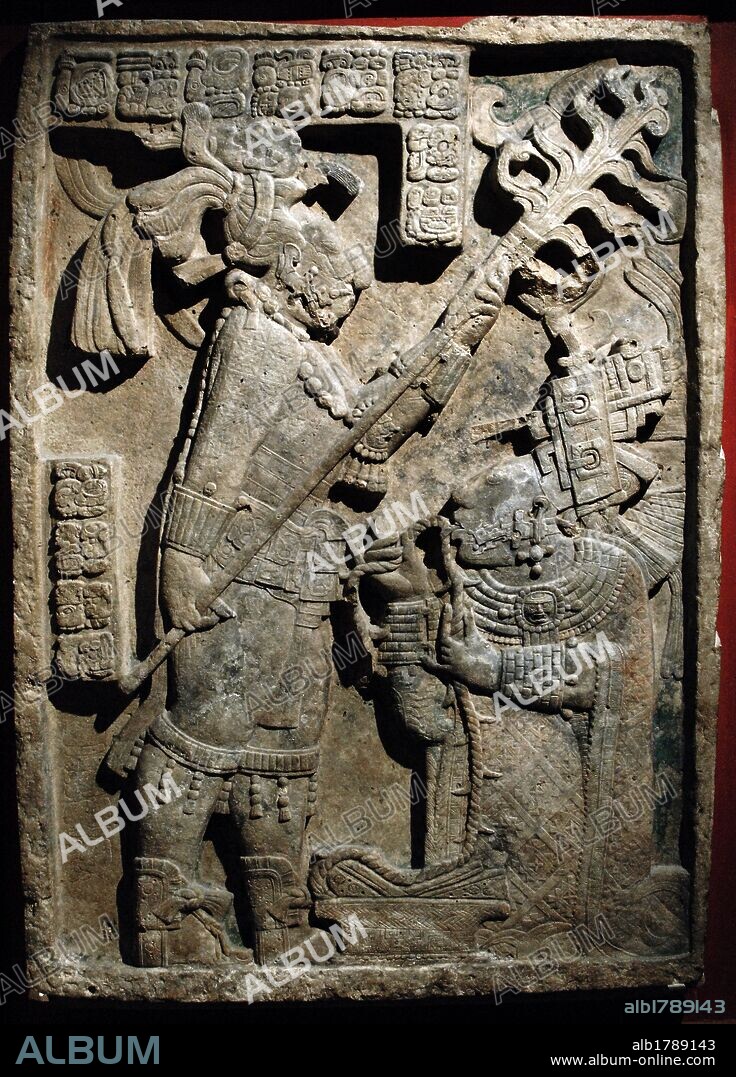 The Yaxchilan Lintels. Lintel 24. Structure 23. Carved limestone lintel. Depiction of a bloodletting ritual performed by the king of Yaxchilan, Shield Jaguar II and his wife, Lady K'ab'al Xook. The king holds a flaming torch over his wife, who is pulling a thorny rope through her tongue. Scrolls of blood can be seen around her mouth. Classic Maya. 723-726. Limestone. Yaxchilan, Chiapas, Mexico. British Museum. London, England, United Kingdom.