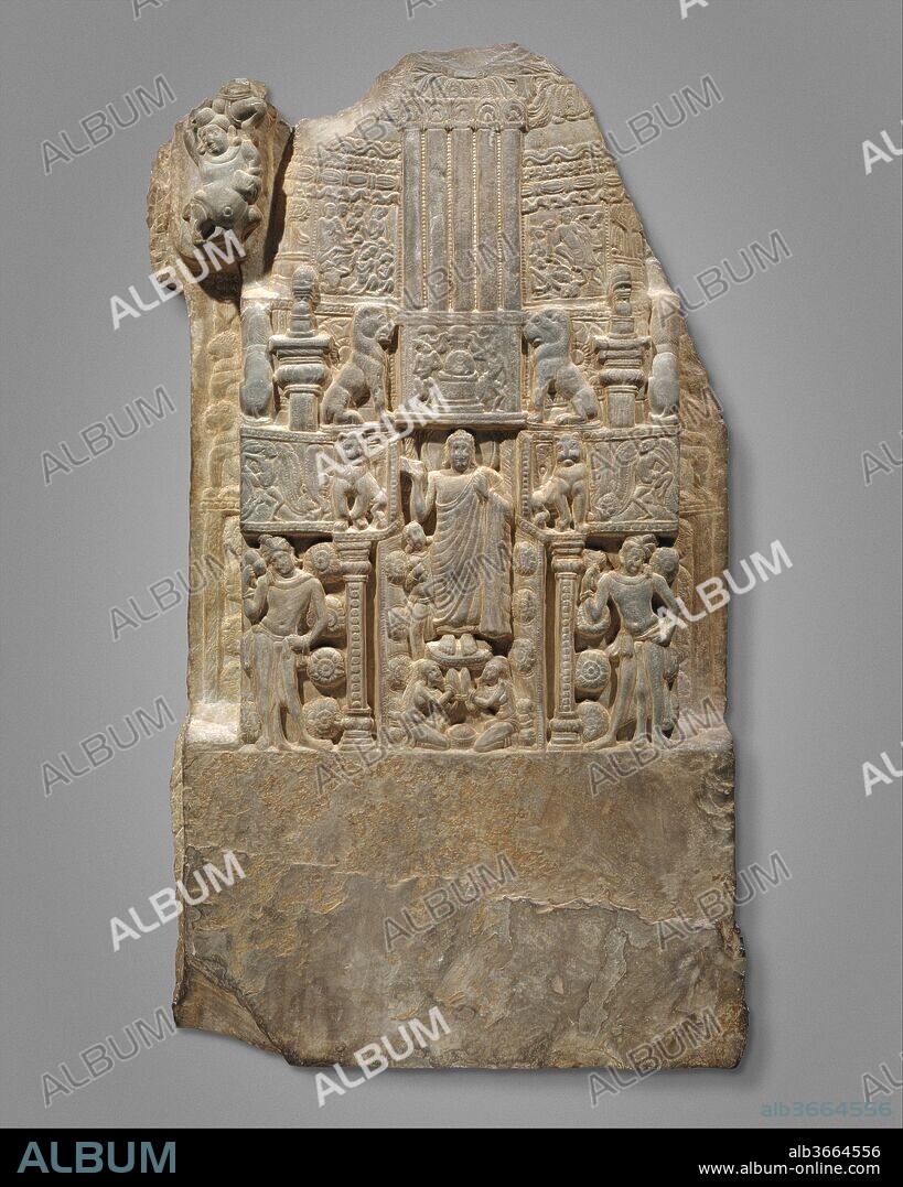 Drum Slab Showing the Buddha Standing in the Gateway of a Stupa. Culture: India (Andhra Pradesh, Nagarjunakonda). Dimensions: H. 48 in. (121.9 cm); W. 29 3/4 in. (75.6 cm); D. 6 3/4 in. (17.1 cm); Est. Wt. 723.3 lbs (328.1 kg). Date: second half of the 3rd century.
This limestone panel was part of a series that encircled the drum of a large stupa. It shows the Buddha standing in the gateway of a stupa being venerated by two female devotees. Attendants holding fly whisks (chauris) stand at either side of the gateway, which is crowned by lions. This detailed imagery documents what a stupa and its embellishing imagery looked like during this period. The somewhat elongated proportions of the people and animals and the corpulence of the Buddha are typical of the art of Nagarjunakonda.