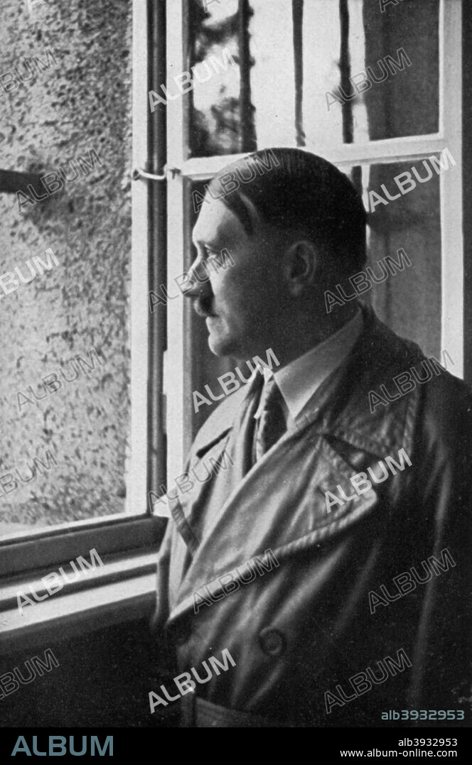 Adolf Hitler looks out of his cell window at Landsberg Fortress, Bavaria, Germany, 1934. Hitler (1889-1945) visiting the prison where he spent 8 months in 1924 for his part in the Munich Beer Hall Putsch, the failed attempt by the Nazis to seize power in Germany on 9 November 1923. A print from Adolf Hitler. Bilder aus dem Leben des Führers, Hamburg: Cigaretten/Bilderdienst Hamburg/Bahrenfeld, 1936.