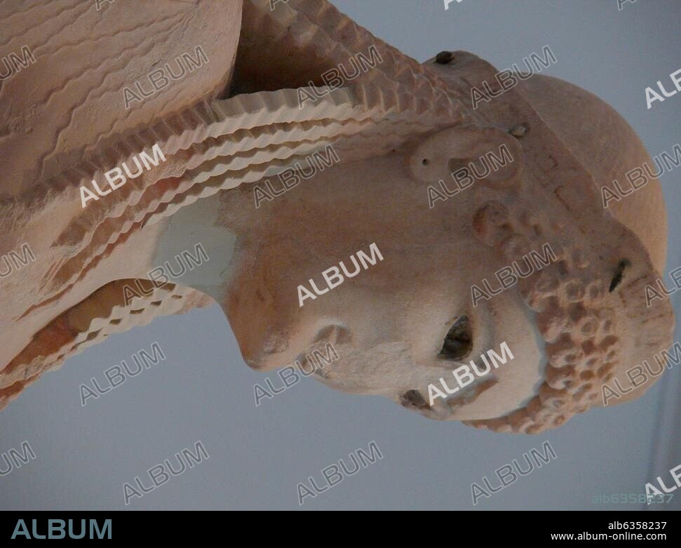 HISTORIC VIEW OF THE OLD ACROPOLIS MUSEUM Kore Attic sculptor artist Antenor donated by Nearchos marble About 520 B.C. view of the kores head her face has a strong geometric outline and a diadem at the top, ringlets frame her face. The eyes of the Kore had been fashioned from rock crystal. Acropolis Museum Greece.