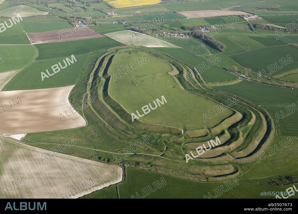 HISTORIC ENGLAND. Maiden Castle, known primarily as an Iron Age multivallate hillfort earthwork, but also contains a Neolithic causewayed enclosure earthwork and long mound earthwork, and the remains of a Roman temple, near Dorchester, Dorset, 2015..