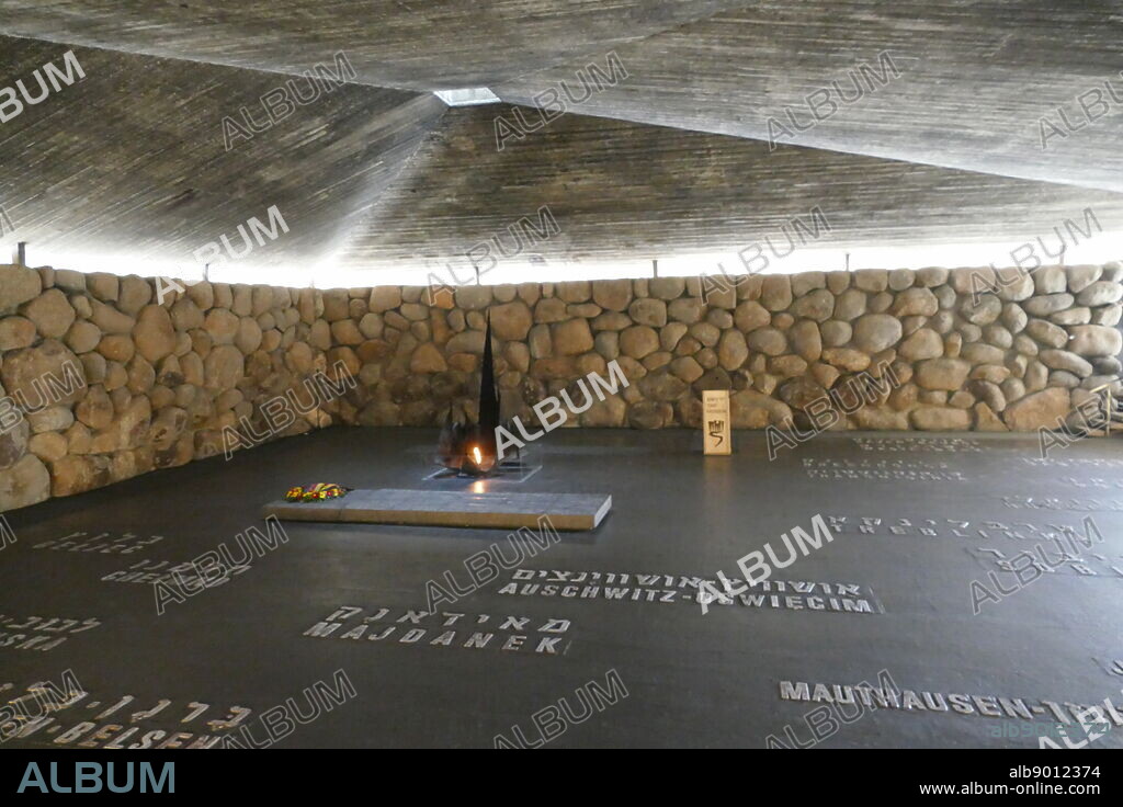 Eternal Flame, in the Hall of Remembrance (Ohel Yiskor), Yad Vashem, Holocaust Memorial, Jerusalem (Israel). Architects: Aryeh Elhanani Eternal Flame: Kosso Eloul. Names of Nazi death camps are set in the floor of the Hall of Remembrance.