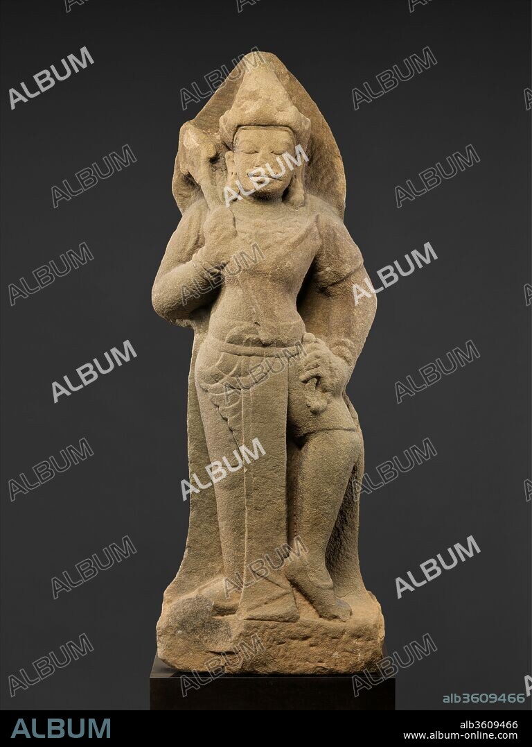 Standing Shiva or Temple Guardian (Dvarapala). Culture: Vietnam (Champa). Dimensions: H. 50 1/2 in. (128.3 cm). Date: ca. first half of the 10th century.
Located on a major sea route between India and China, Champa, in the central part of Vietnam, played an important role in early Southeast Asian history. This rare sculpture, which may represent either a temple guardian or the Hindu god Shiva, shows the rugged sculpting and distinctive physiognomy, particularly the prominent mustache, that typify the art of the Chams. He wears a short wrap, which features a long front pocket with an oblique upward curve, and a sash. He carries a rosary in his left hand and a club or trident in his right. An early tenth-century date is suggested by stylistic parallels to sculptures in contemporaneous buildings at Mi Son, an important site dedicated to Shiva, as well as further southeast at Khoung My.