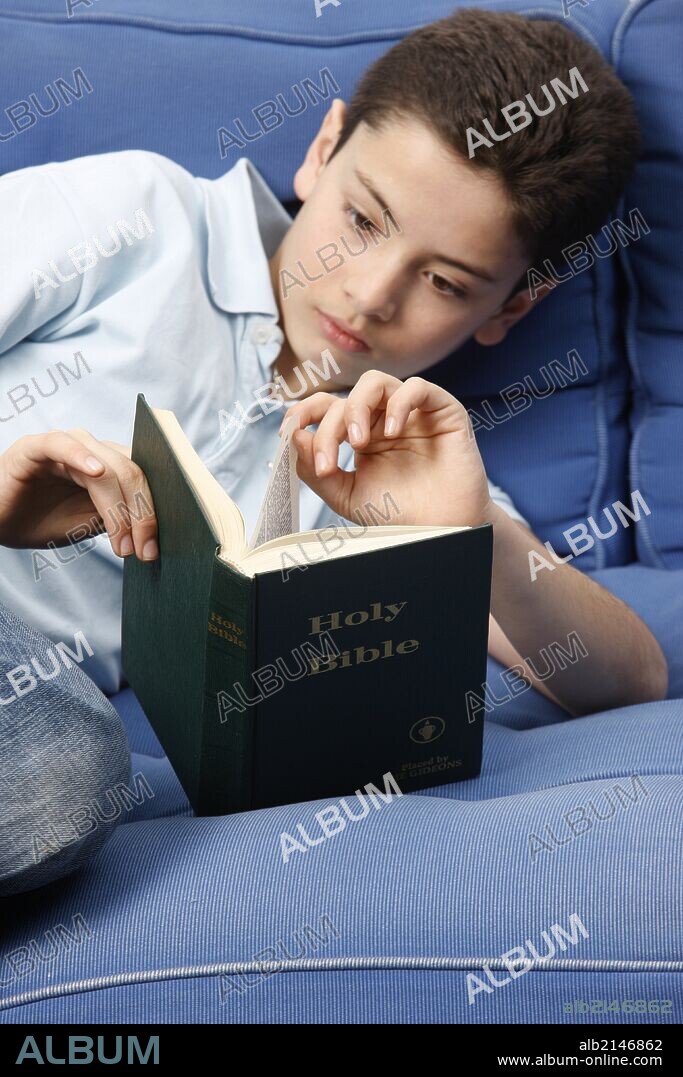 Boy reading Bible.