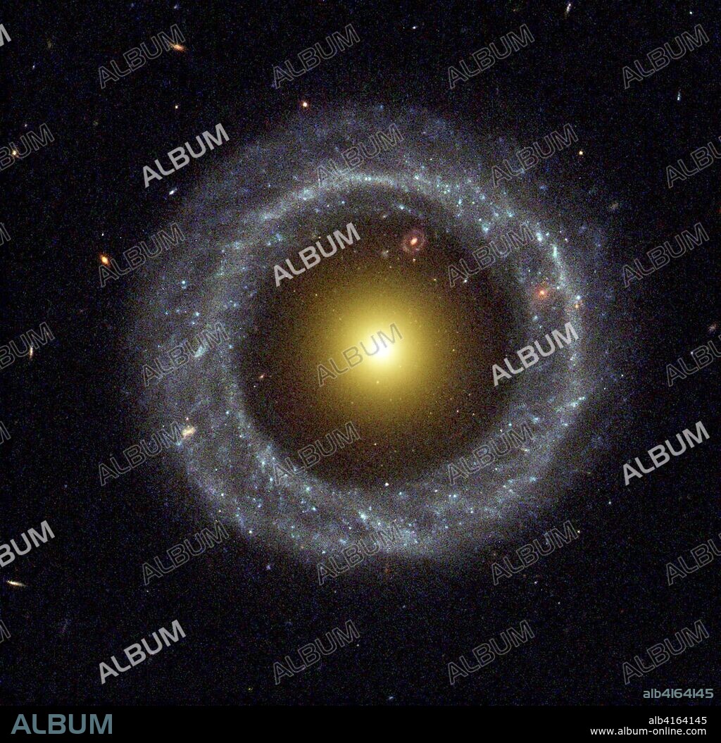 US SPACE NEW HUBBLE IMAGE:DCA01 - 20020905 - WASHINGTON, DC, UNITED STATES : This NASA Hubble Space Telescope image released 05 September, 2002 shows a nearly perfect ring of hot, blue stars pinwheels about the yellow nucleus of an unusual galaxy known as Hoag's Object. This image captures a face-on view of the galaxy's ring of stars, revealing more detail than any existing photo of this object. The image may help astronomers unravel clues on how such strange objects form.The entire galaxy is about 120,000 light-years wide, which is slightly larger than our Milky Way Galaxy. The blue ring, which is dominated by clusters of young, massive stars, contrasts sharply with the yellow nucleus of mostly older stars. What appears to be a "gap" separating the two stellar populations may actually contain some star clusters that are almost too faint to see. . EPA PHOTO AFPI/NASA/kb/eh.