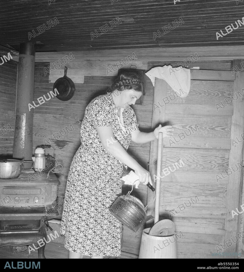 DOROTHEA LANGE. Wife of tobacco sharecropper cleaning butter churn, Person  County, North Carolina,1939. Creator: Dorothea Lange. - Album alb5550354