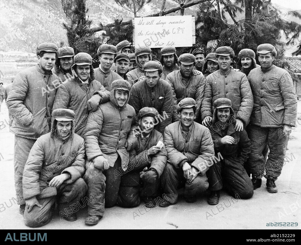 Korean War. A happy group of American prisoners in a North Korean POW camp. 1953. The sign behind them reads: 'We will always remember the kindness of the C.P.V. (Chinese People's Volunteers) and their help.' (Photo by: Sovfoto/UIG via Getty Images).