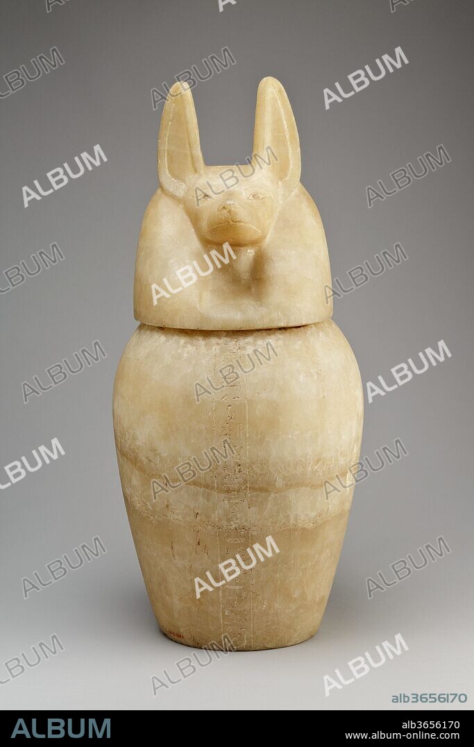 Canopic jar with a jackal-headed lid. Dimensions: Jar with Lid: H. 49 cm (19 5/16 in.); Diam. 22.8 cm (9 in.); Jar: H. 28.3 cm (11 1/8 in.); D. 23.6 cm (9 5/16 in.); Diam. at base 14 cm (5 1/2 in.); Diam. at mouth 14 cm (5 1/2 in.); Circ. 70 cm (27 9/16 in.); Lid: H. 22.3 cm (8 3/4 in.); W. 17.4 cm (6 7/8 in.); D. 19.7 cm (3/4 in.); Diam. of foot 12.4 cm (4 7/8 in.). Dynasty: Dynasty 26. Date: 664-525 B.C..
Canopic jars were made to contain the embalmed viscera removed from the body in the process of mummification.  The organs were placed under the protection of the Four Sons of Horus, whose heads form the lids of the jars: Hapy (baboon-headed), Imsety (human-headed), Duamutef (jackal-headed), and Kebehsenuef (falcon-headed).  In turn these gods were under the protection of the goddesses Nephthys, Isis, Neith, and Selket, respectively, as the inscriptions on the jars state.
This jar was under the protection of Duamutef and Neith and would probably have contained the stomach.