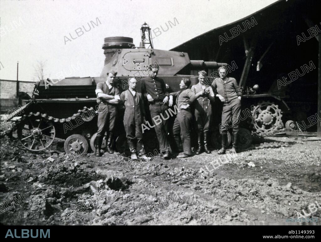 German tankers pose in front of a Tiger that is in need of repair, WW2.