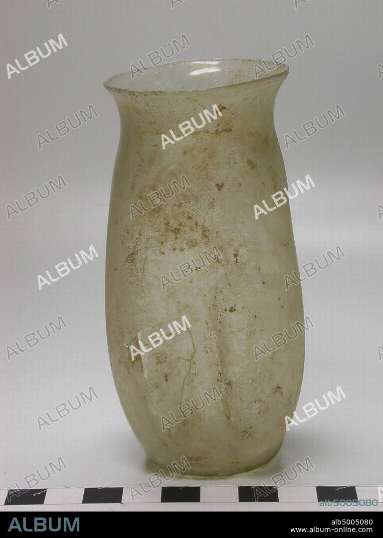 White glass cup on a flat foot and with a wide mouth. The belly is provided with four indentations, tableware, glass, H 10.5 cm, Syria.