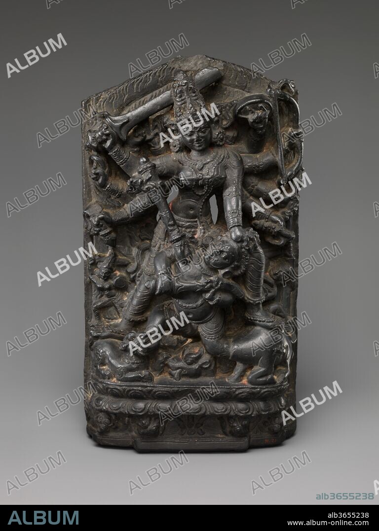 The Goddess Durga Slaying the Buffalo Demon(Mahishasura Mardini). Culture: India (Bihar). Dimensions: H. 11 1/2 in. (29.2 cm); W. 6 1/2 in. (16.5 cm); D. 3 1/2 in. (8.9 cm). Date: ca. 11th century.
Durga slays Mahisha, who emerges in his anthropomorphic form, one foot still in the neck of the decapitated buffalo and the other in the mouth of Durga's lion. Her army of followers is suggested by the small sword-wielding female warriors that bracket her feet.