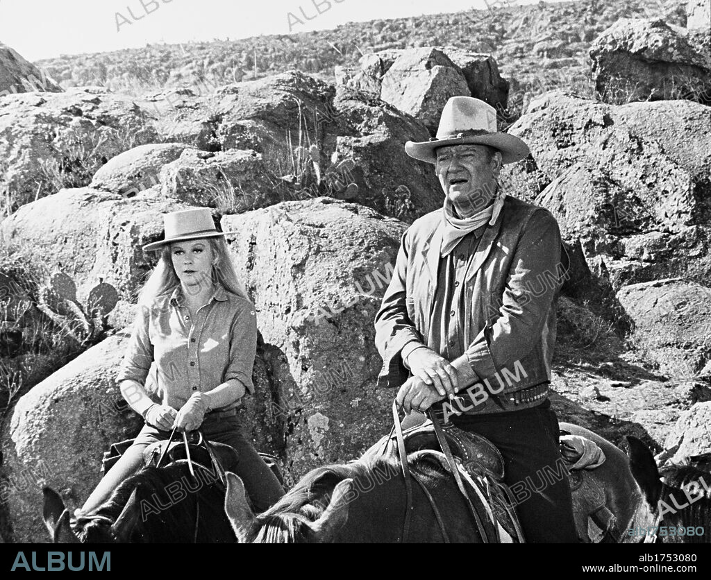 ANN-MARGRET and JOHN WAYNE in THE TRAIN ROBBERS, 1973, directed by BURT KENNEDY. Copyright WARNER BROTHERS.