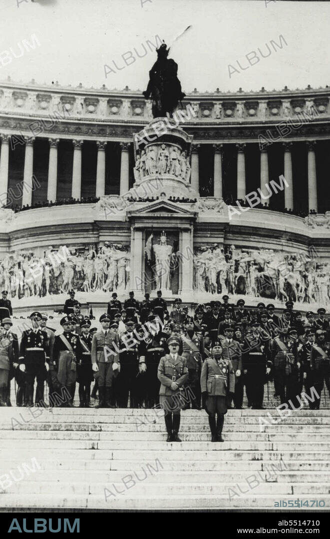 Dictators Meet - Hitler and Mussolini standing together on the steps of the unknown soldier's Grave in the Piazza Venezia, Rome, today, where Hitler placed a wreath of Laurel. Behind the dictators are ministers of Italy and Germany.
Herr Hitler and Signor Mussolini drove together in an open car through the streets here this morning to the Piazza Venezia, the pantheon and the fascist party. The two dictators stood up throughout their drive. June 19, 1938. (Photo by Associated Press Photo).