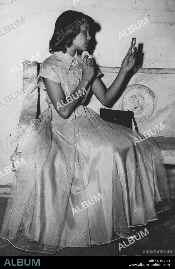 Monica Ingram, an aboriginal girl, shows off the dress she will wear at the Black and white Ball in Perth on October 29. Natives, half-castes and whites will dance together at the ball for the first time in Perth's history. October 07, 1953. ;Monica Ingram, an aboriginal girl, shows off the dress she will wear at the Black and white Ball in Perth on October 29. Natives, half-castes and whites will dance together at the ball for the first time in Perth's history.