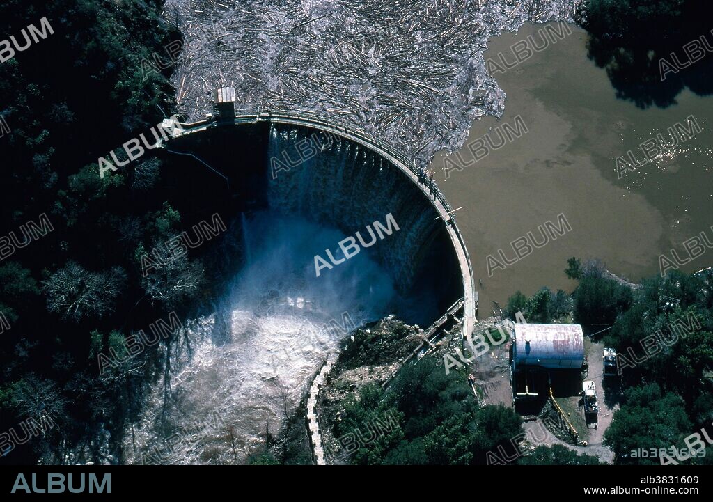 Los Padres Dam near flood stage; Carmel Valley, CA, February 1998. El Nino is caused by weak westward trade winds which allow warm water to remain near South America. This mass of warm water affects global weather, causing massive storms on the American continent. Its name, (Spanish for "the child), is derived from its arrival during the Christmas season.