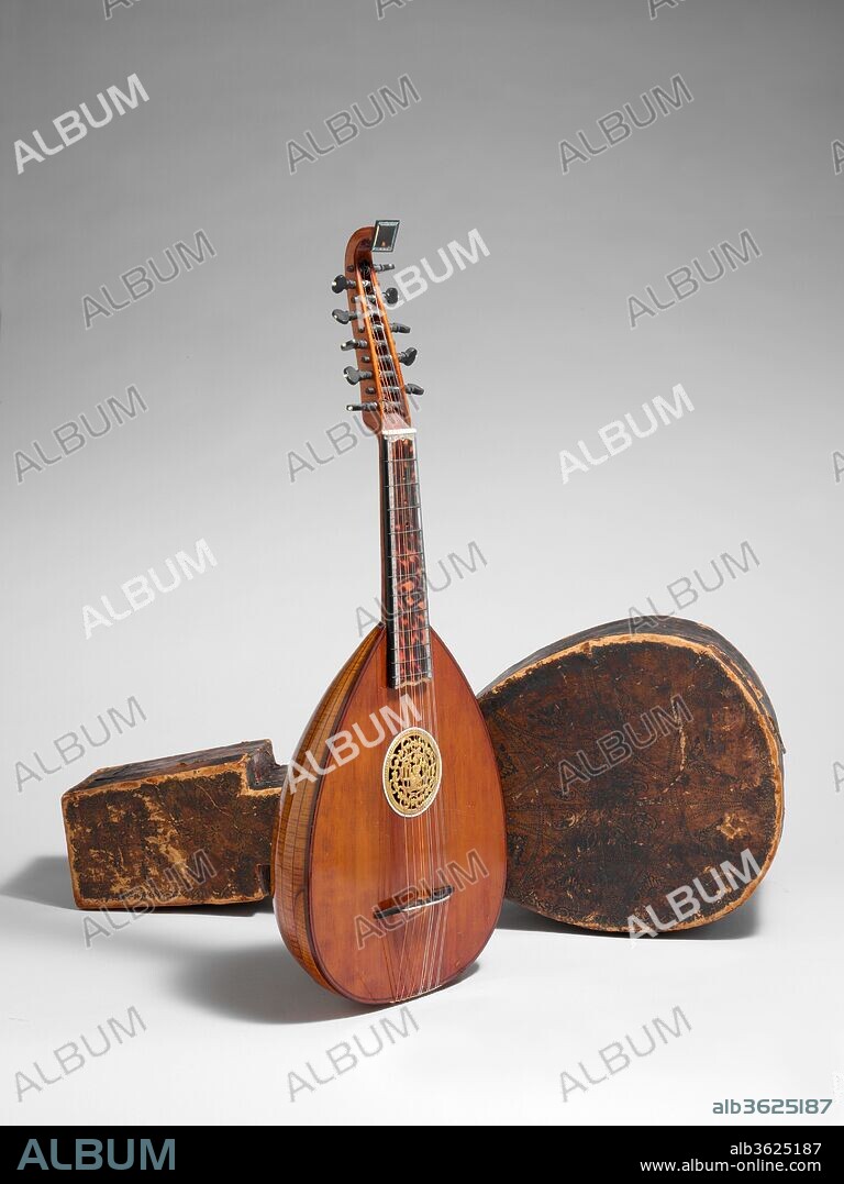 English Guitar. Culture: British. Dimensions: L. 73.5 cm (28-15/16 in); String L. 45 cm (17-13/16 in). Date: late 18th century.
Unusual form with arched back of 21 flamed maple ribs, decorated with engraved mother-of-pearl and tortoiseshell veneer. The label within is illegible.  Original tooled leather case. London, late 18th century.