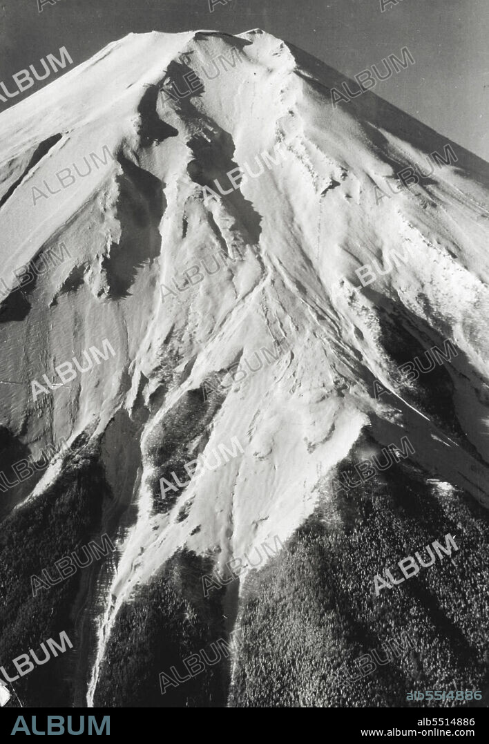 The biggest avalanche in the history of Mt. Fuji--Japan's sacred mountain -- on November 29th swept 16 University students thousands of feet to their deaths. Three students had miraculous escapes, emerging alive after they had been swept nearly 1000 feet.
The course of the avalanche can be seen in the deep cleft of the let bottom *****. January 11, 1955.