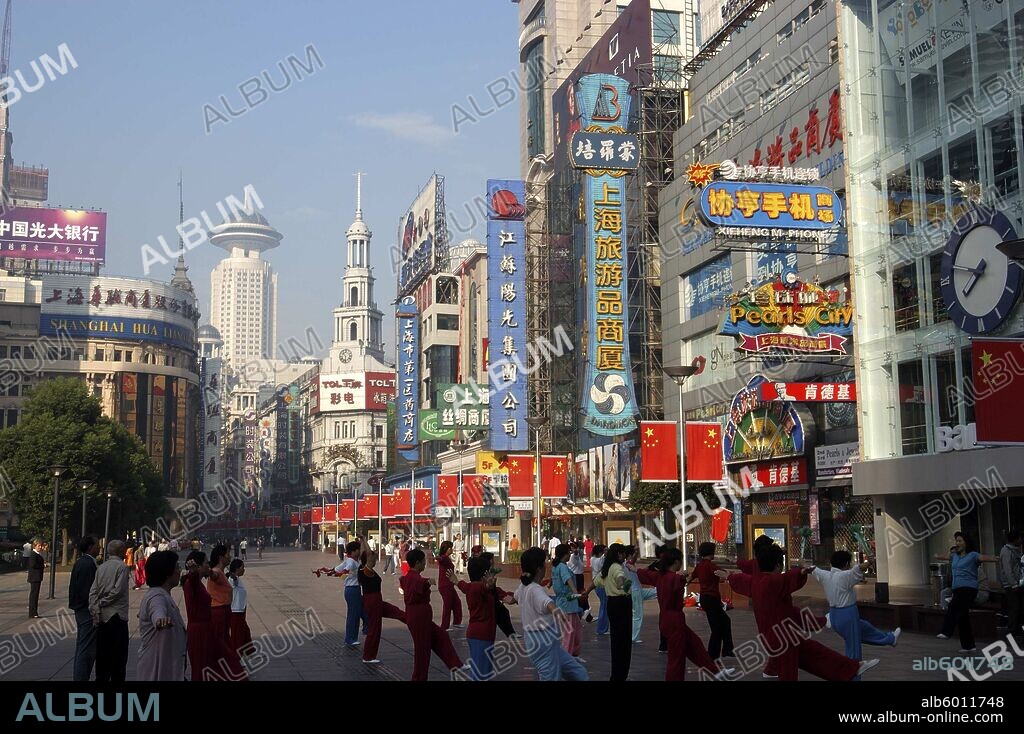 CHINA Shanghai Nanjing Road walking street. Commercial shopping street with  group of people exercising outside. - Album alb6011748