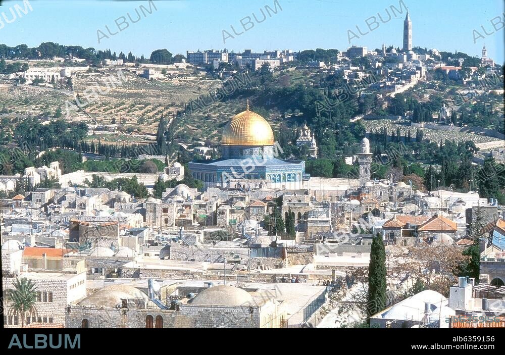 1404. JERUSALEM, VIEW TO THE EAST; THE MUSLEM QUARTER OF THE OLD CITY IN THE FRONT, THE TEMPLE MOUNT WITH THE GOLDEN DOME OF THE DOME OF THE ROCK IN THE CENTRE AND THE MT. OF OLIVES IN THE BACKGROUND.