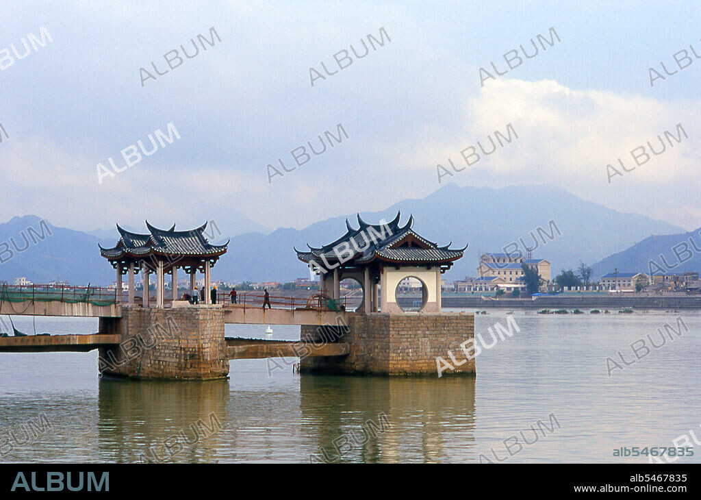 Guangji Bridge (Guang Ji Qiao; literally 'Great Charity Bridge'), also known as Xiangzi Bridge is an ancient bridge that crosses the Han River in Chaozhou. The bridge is renowned as one of China's four famous ancient bridges; the other three are the Zhaozhou Bridge, the Luoyang Bridge and the Lugou Bridge. The Guangji was originally a pontoon bridge built in AD 1170 during the Southern Song Dynasty with a length of 518 metres (1,699 ft). Later, construction of piers and framework started from both banks of the river on which it was moored, and 200 years later the current form of the bridge, with a floating section supported by 18 wooden pontoons between two beamed sections, was completed. The floating section can be disconnected for the passage of large boats, an innovation that set a precedent in bridge-building history. Chaozhou is believed to have been founded more than 1700 years ago. The town reached its zenith during the Ming era and was well known as a place of great culture as well as an important commercial and trading centre. Teochew dialect, by which the Chaozhou culture is conveyed, is one of the most conservative Chinese dialects because it preserves many contrasts from ancient Chinese that have been lost in some of the other modern dialects of Chinese.