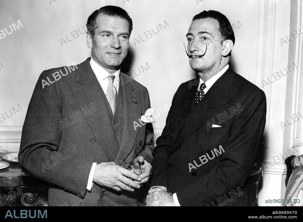 Surrealist painter Salvador Dali (right) meets the man he has come from France to paint, Actor Sir Laurence Olivier in London this evening (Tuesday).. Dali's portrait will show Sir Laurence Olivier in his role as Richard III for his new film and will probably try to capture the good and the bad parts of the King's character - perhaps by including tow.. 26 APril 1955.