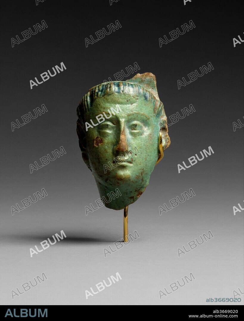 Head, Ptolemy III (?). Dimensions: H. 4.4 cm (1 3/4 in.); W. 3 cm (1 3/16 in.); D. 2 cm (13/16 in.). Reign: reign of Ptolemy III Euergetes I. Date: 246-222 B.C..
Wearing the diadem of a Ptolemaic ruler, this head is thought to represent Ptolemy III. 
The head is broken away from a vessel, probably a shallow cup or a bowl. These types of vessels served for libations in Greek culture, their centers adorned by a relief head (termed an emblema) of a figure from the circle of Dionysius. In Egypt, where the rulers associated themselves strongly with Dionysius, the divine emblema was often replaced by the head of Alexander or a Ptolemaic king.