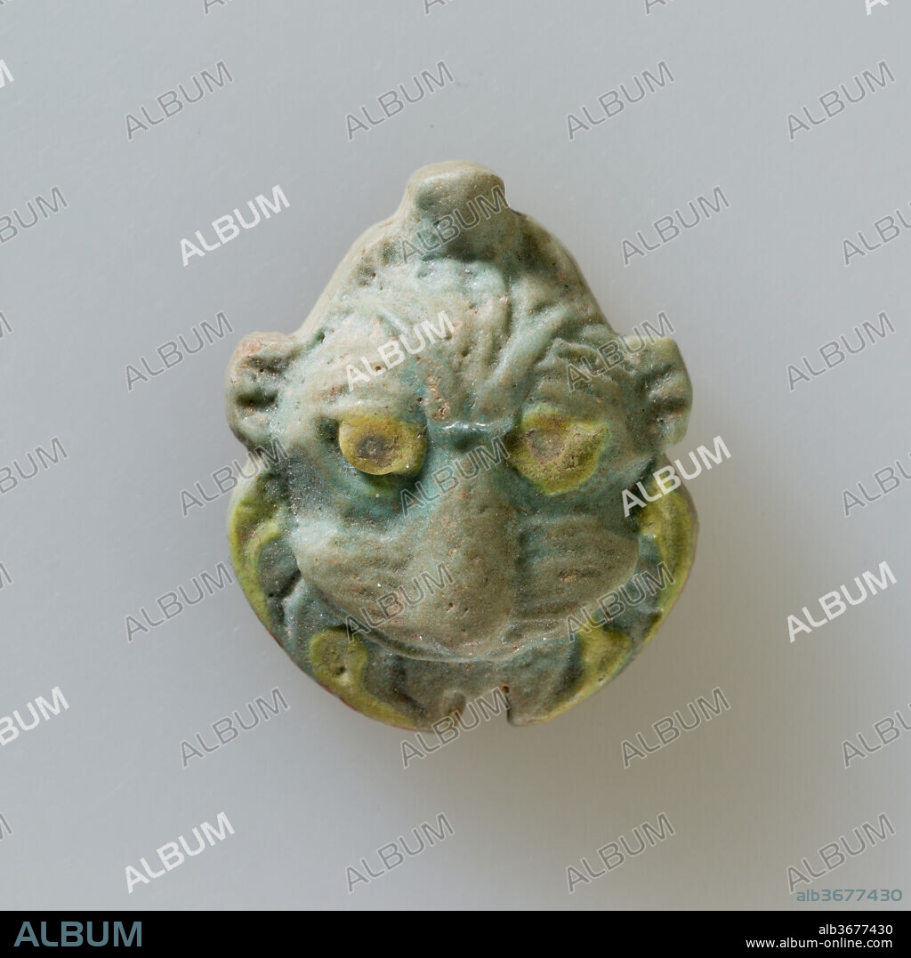 Lion head amulet. Dimensions: l. 2.6 cm (1 in.) × w. 2.1 cm (13/16 in.). Date: 664-30 B.C..
This lion head amulet exhibits changes in the representation of lions that appeared during the later first millennium BC. The forehead is smaller and the face drawn downward, and there is emphasis on the mane beneath the cheeks.