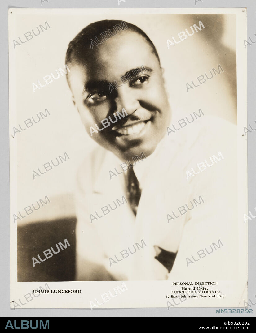 A silver gelatin print depicting a black-and-white image of Jimmie Lunceford. He is depicted in three quarters profile, in bust pose, looking towards the right side of the image. He is wearing a white jacket, white shirt, and a dark pattern tie and pocket square. He is smiling as he leans toward the left side of the image. The image is bordered with white and along bottom is black text on the left and right sides. The text in the lower left corner reads, [JIMMIE LUNCEFORD]. The text in the lower right corner reads, [PERSONAL DIRECTION / Harold Oxley / LUNCEFORD ARTISTS Inc. / 17 East 49th. Street New York City]. There are several inscriptions in pencil on the back of the photograph.
